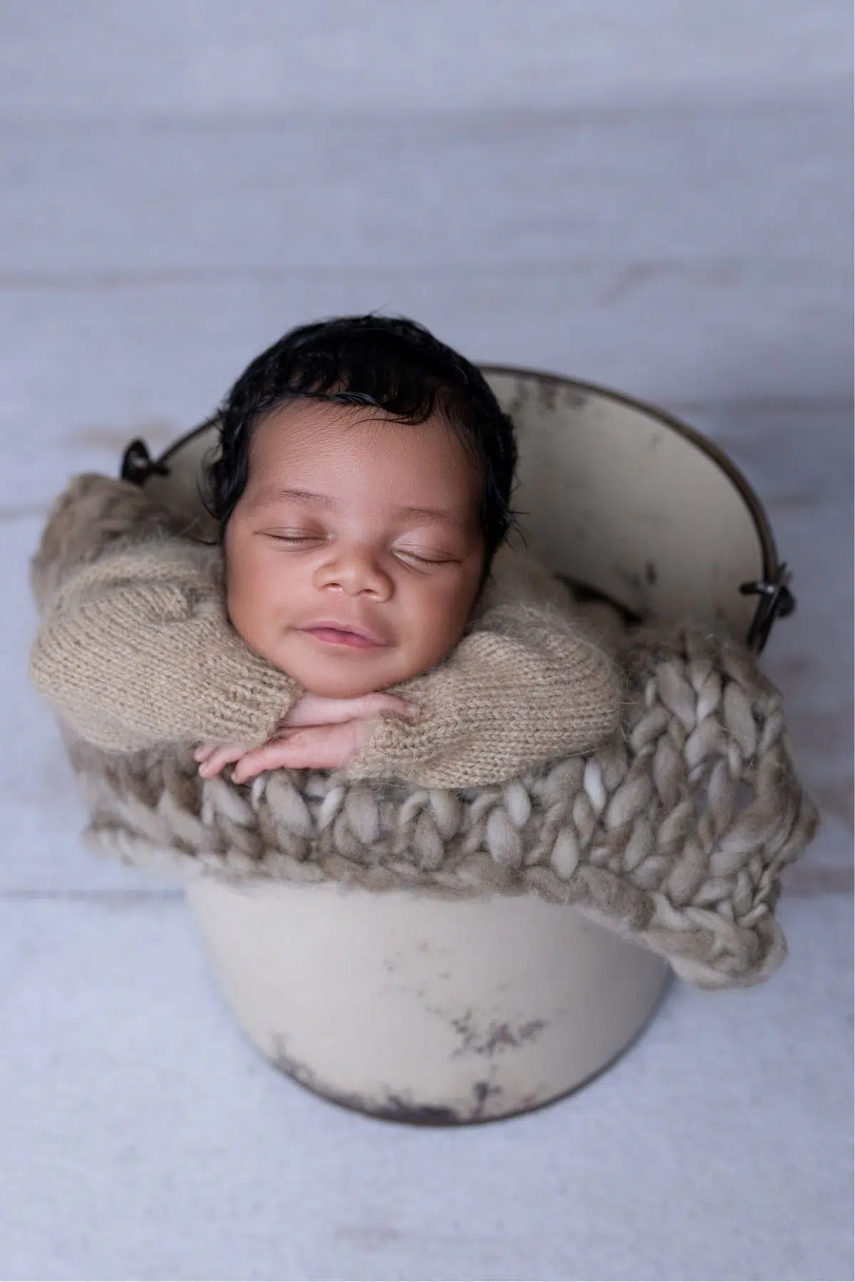 High end fine art studio Newborn baby girl boy smile Image purple pastel color colorful bucket rustic vintage photographed by Cynthia Hamilton Photography in Georgetown,TX Newborn in rustic bucket, cozy setting.